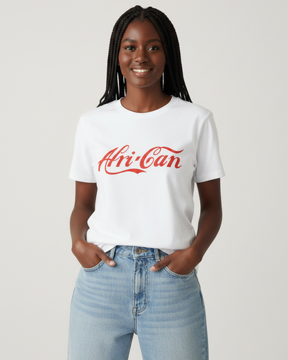 Black woman in her early mid-late 20's, with braided hair, stands confidently against an off-white studio background. She is wearing a whitet-shirt with the word Afri-Can in red font, reminiscent of the Coca Cola font and logo.