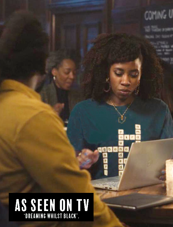 Woman using a laptop with text overlay 'As Seen on TV Dreaming Whilst Black'.